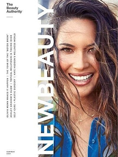 Smiling woman on New Beauty magazine cover.