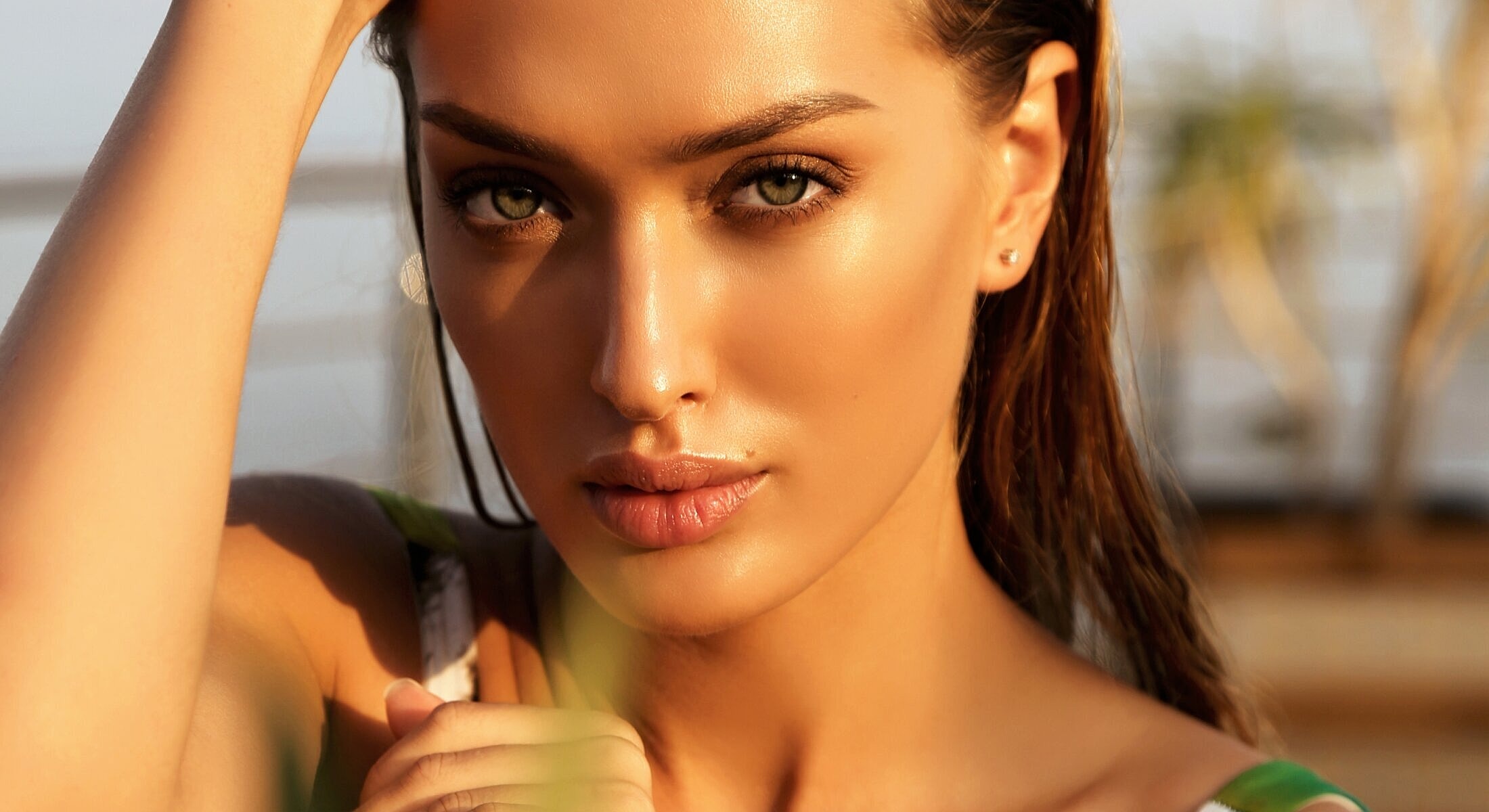 Woman with glowing skin and intense gaze.